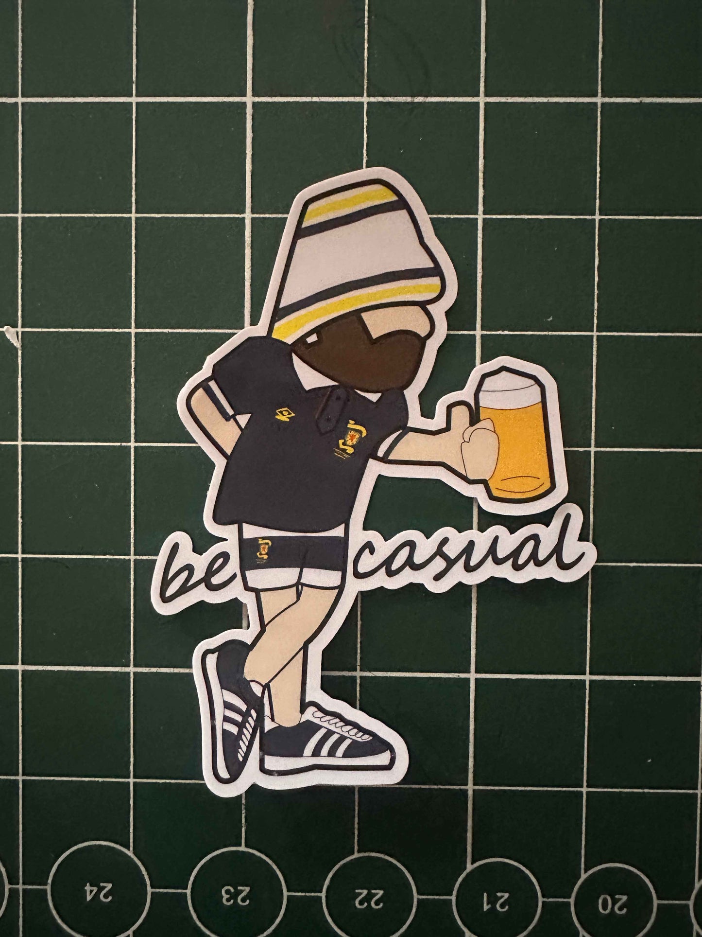 Be Casual scotland sticker in scotland home kit holding a beer subculture 
